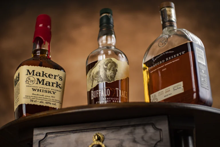 A Picture of a table with Maker's Mark, Buffalo Trace and Woodford Reserve Bourbon
